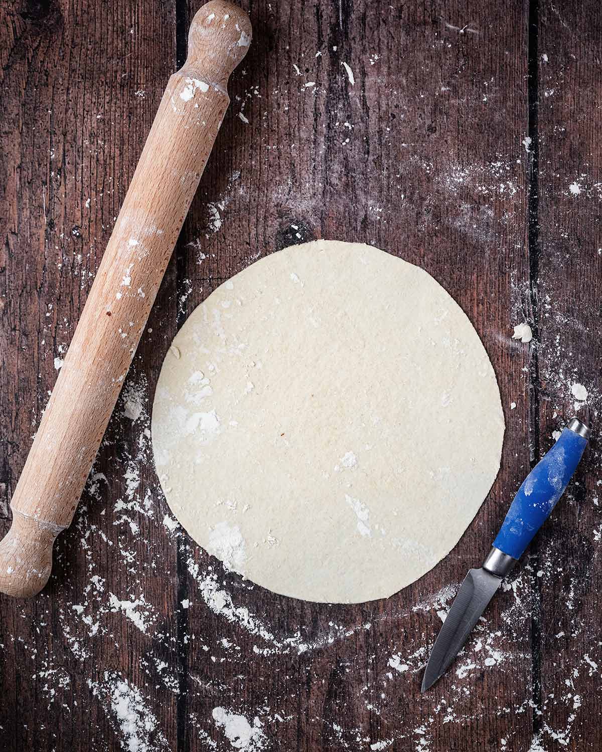 The dough rolled out and cut into a circle.