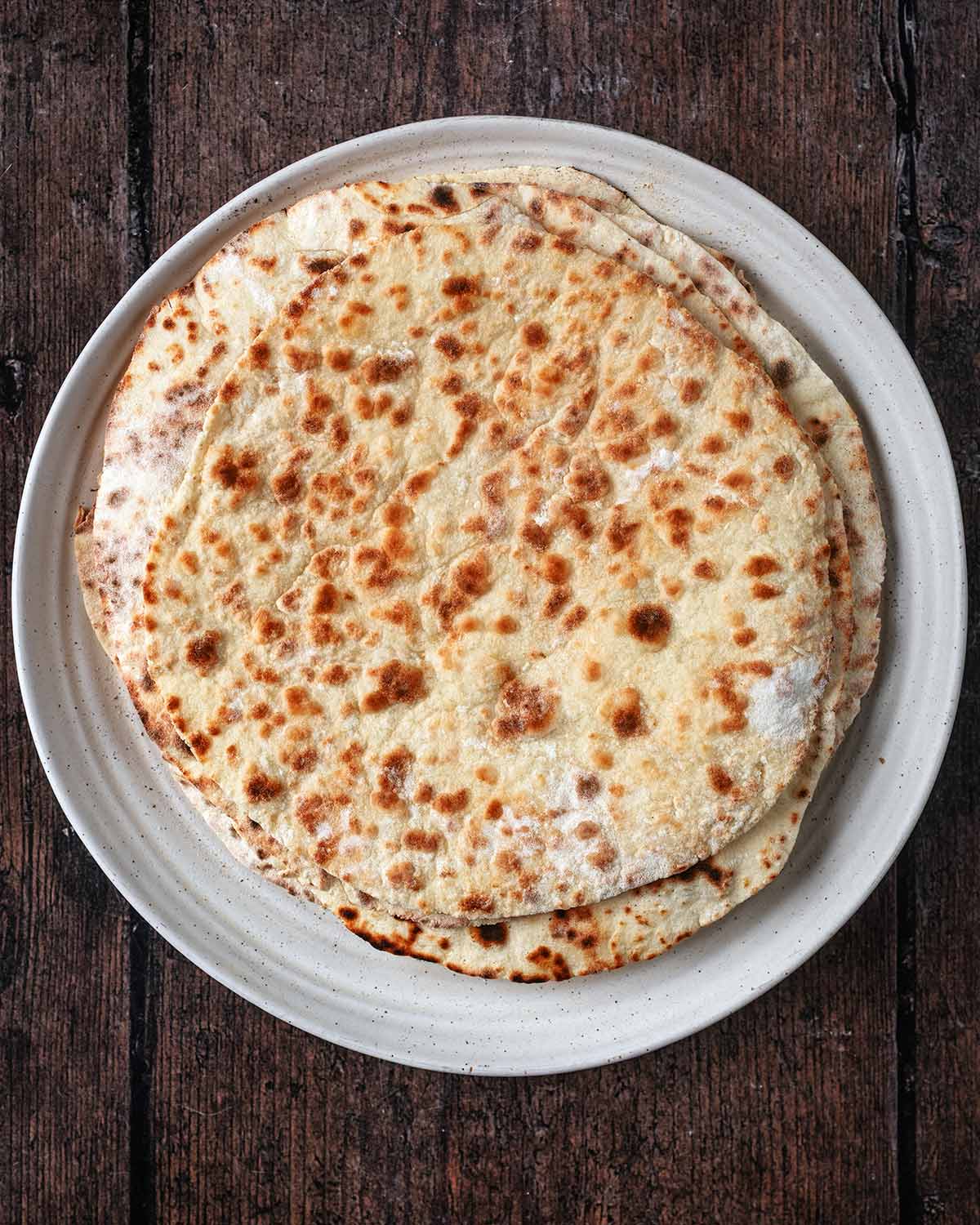 Cooked flatbreads on a plate.