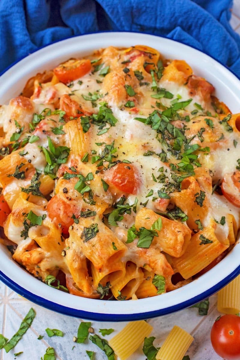 A blue rimmed white bowl containing Pasta Bake.