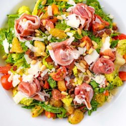 Italian Chopped Salad with Parma Ham in a large white bowl.
