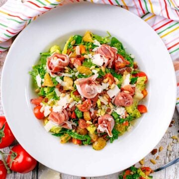 A large white bowl containing Italian chopped salad.