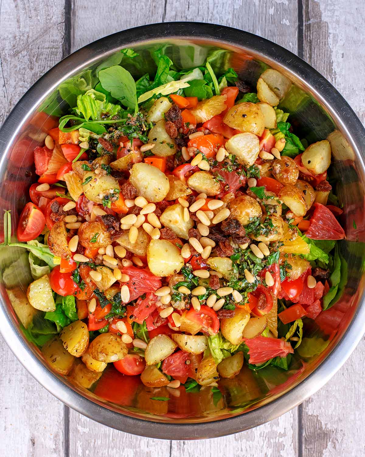 Dressing, dried fruit and pine nuts added to the salad.