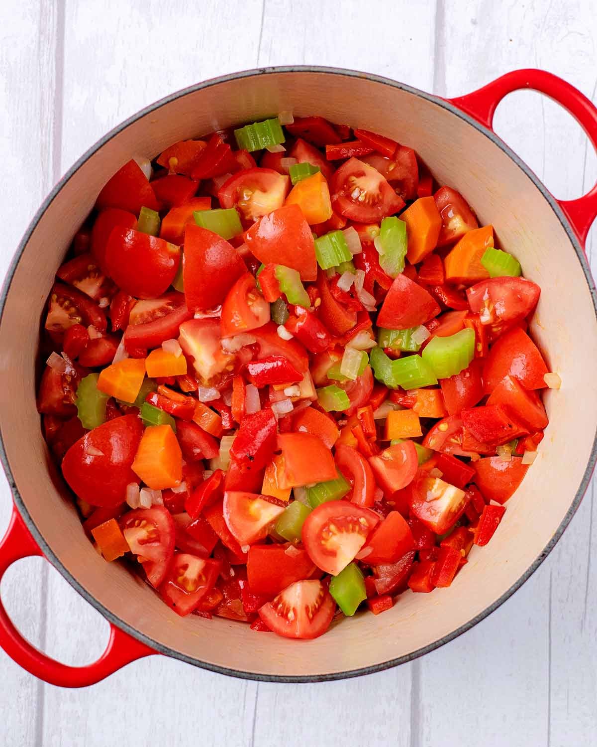 Chopped tomatoes and red peppers added to the pan.