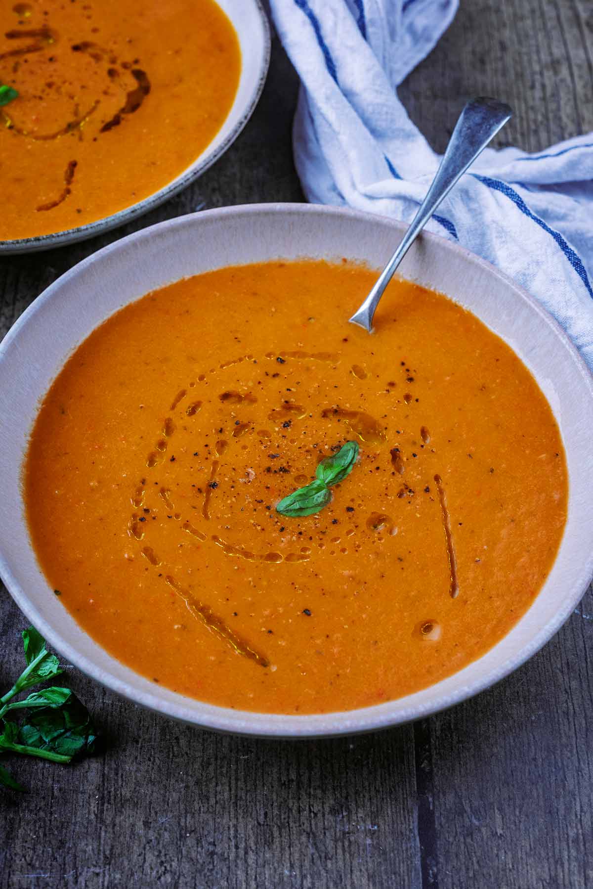 a bowl of soup with another bowl behind it.