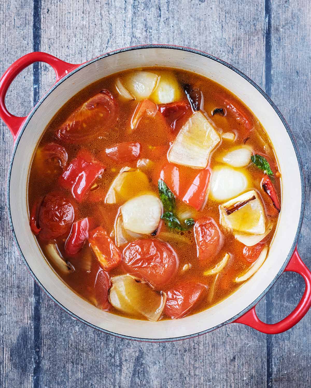 The vegetables and stock cooked in the pot.