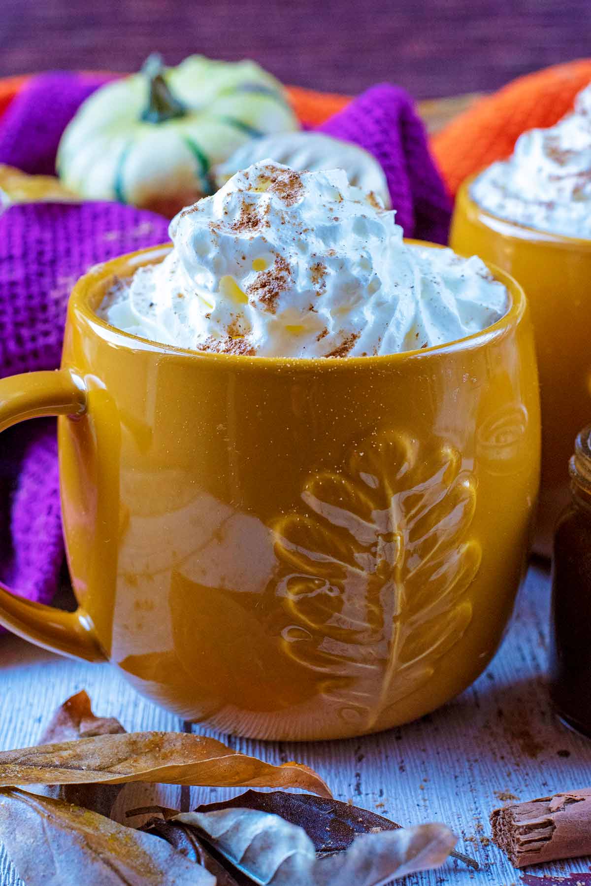 A mug of cream topped pumpkin spiced latte.