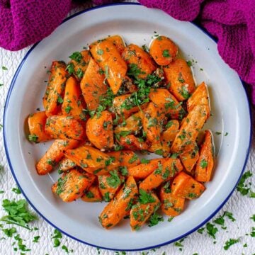Garlic and Parsley Roasted Carrots in a white bowl.