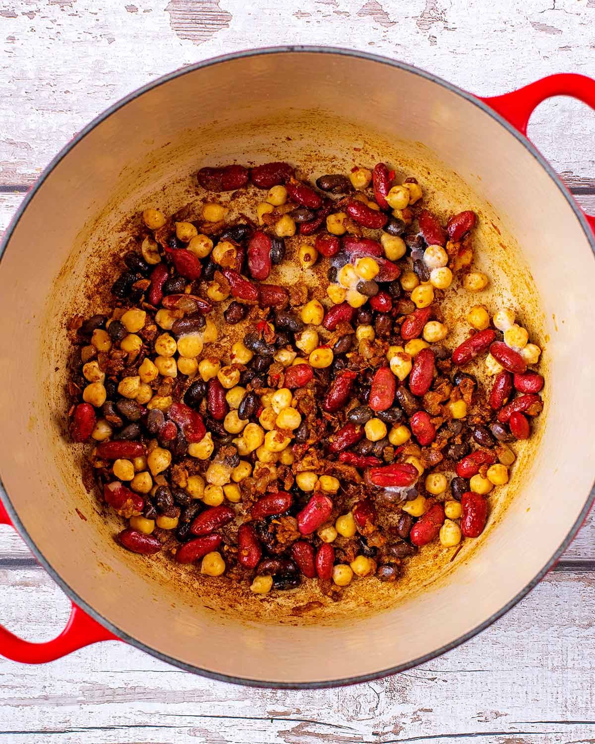 Beans and chickpeas added to the pan.