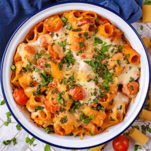 A white bowl with a blue rim containing Creamy Tomato Chicken Pasta Bake.