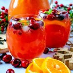 Christmas Punch next to some fresh cranberries and orange slices.