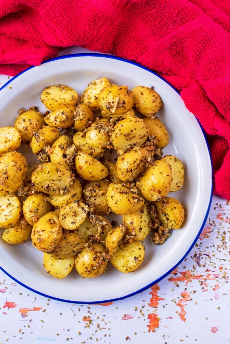 Italian Roasted Potatoes in a white, blue rimmed dish.