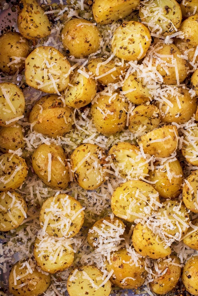 Roasted new potatoes covered in herbs and grated cheese.
