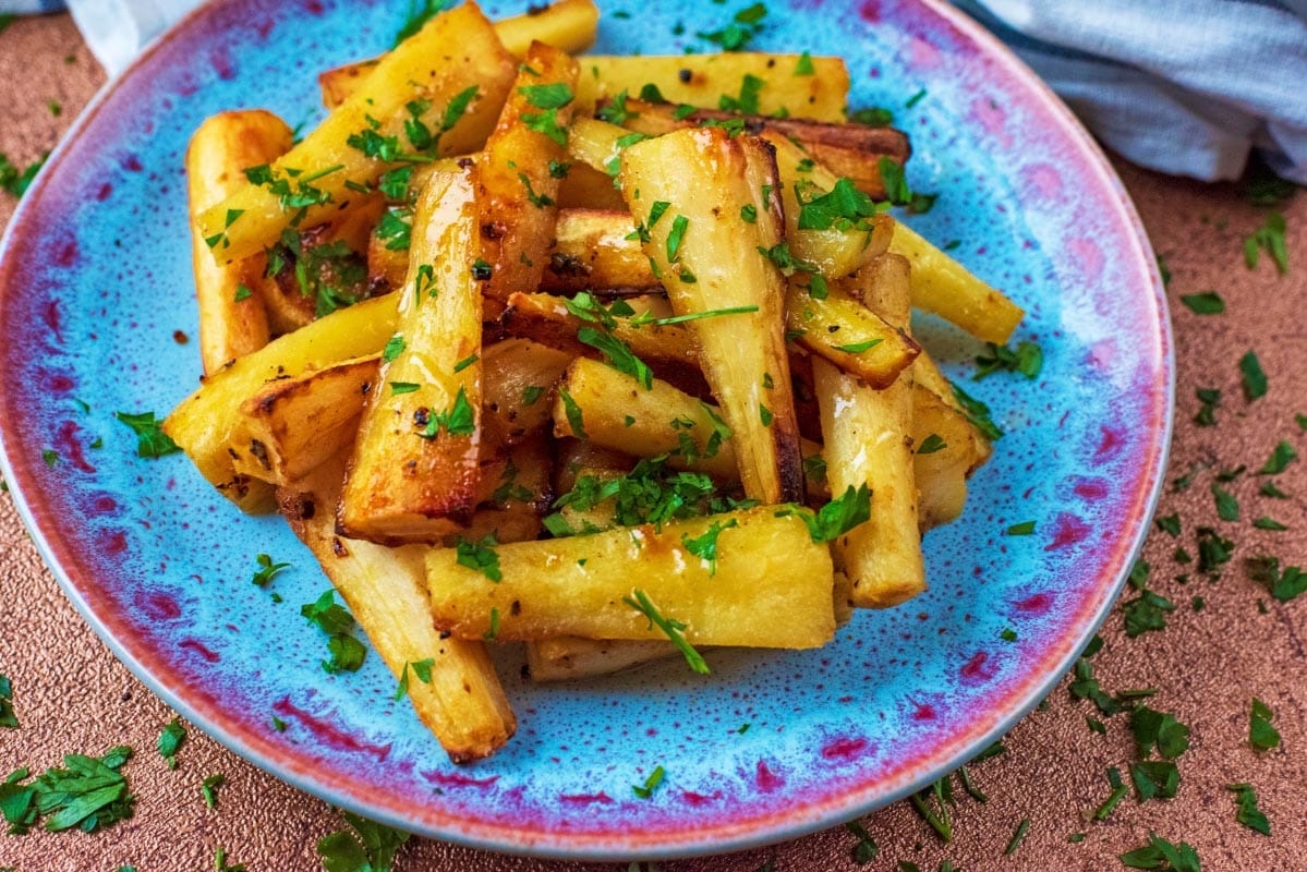 Mustard and Honey Roasted Parsnips on a blue plate.