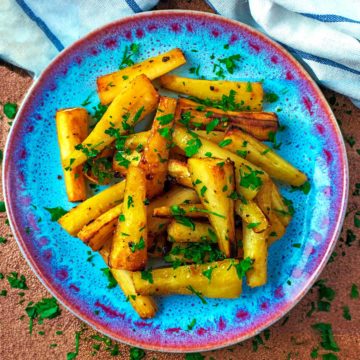 Honey Roasted Parsnips on a blue plate.