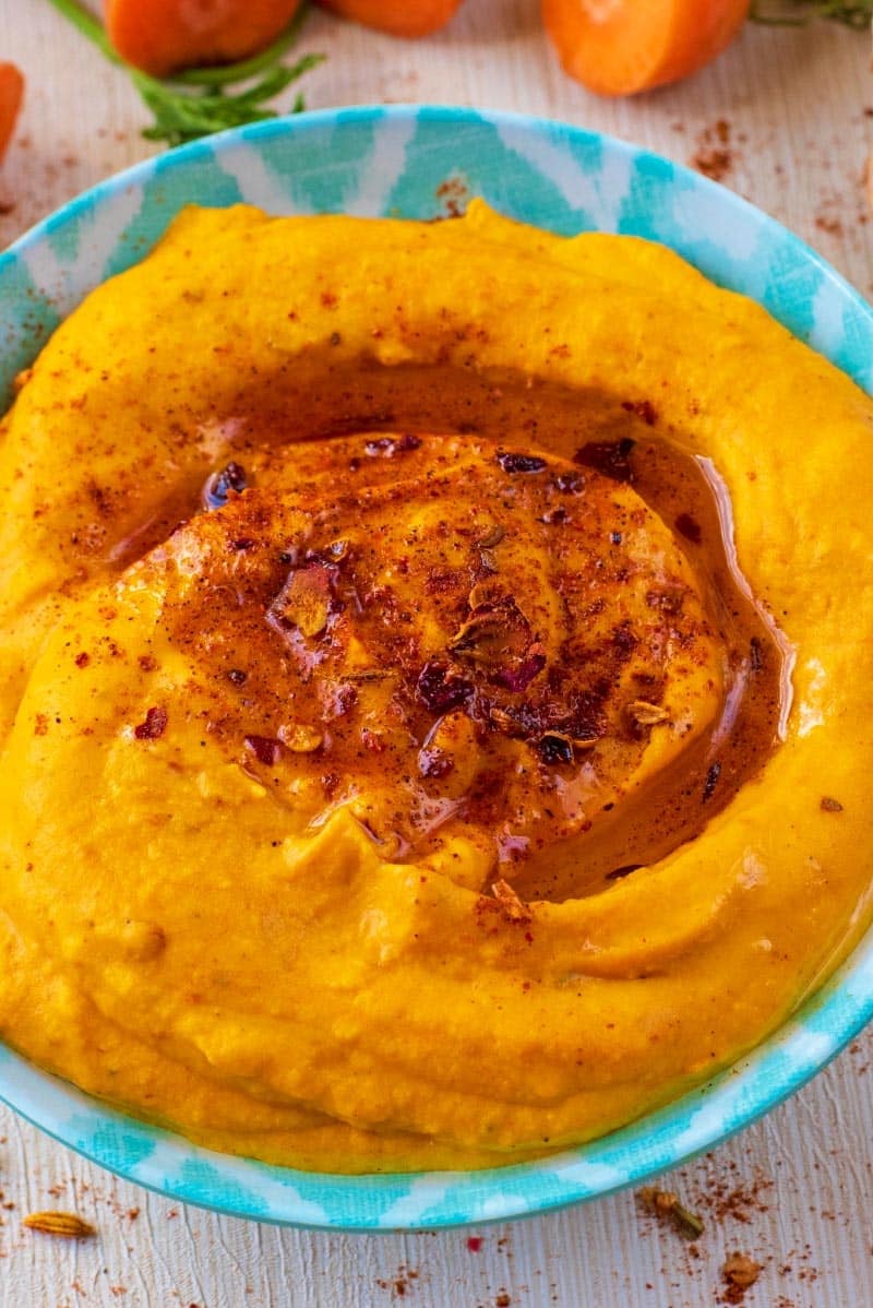 Carrot Hummus swirled with oil and ras-el-hanout.
