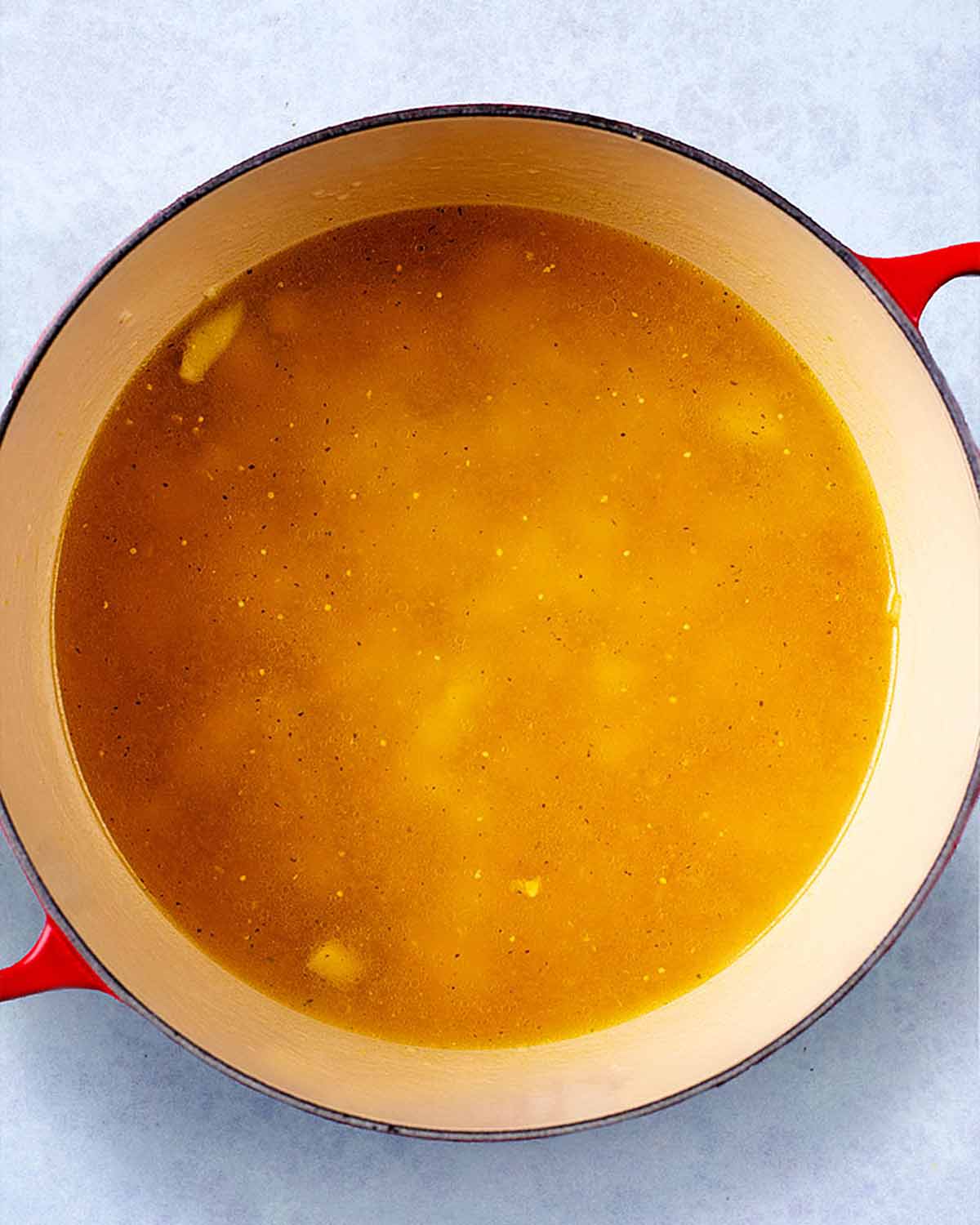 Stock added to the pan.