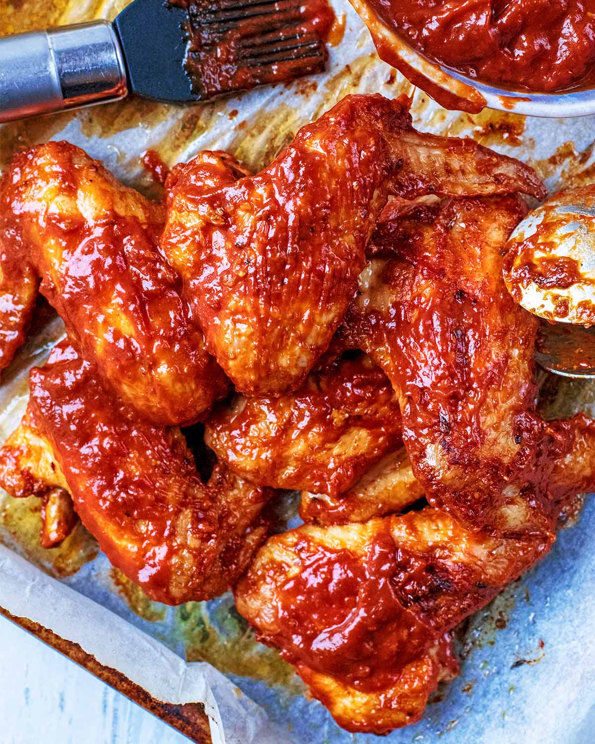 Crispy baked chicken wings on a baking tray.