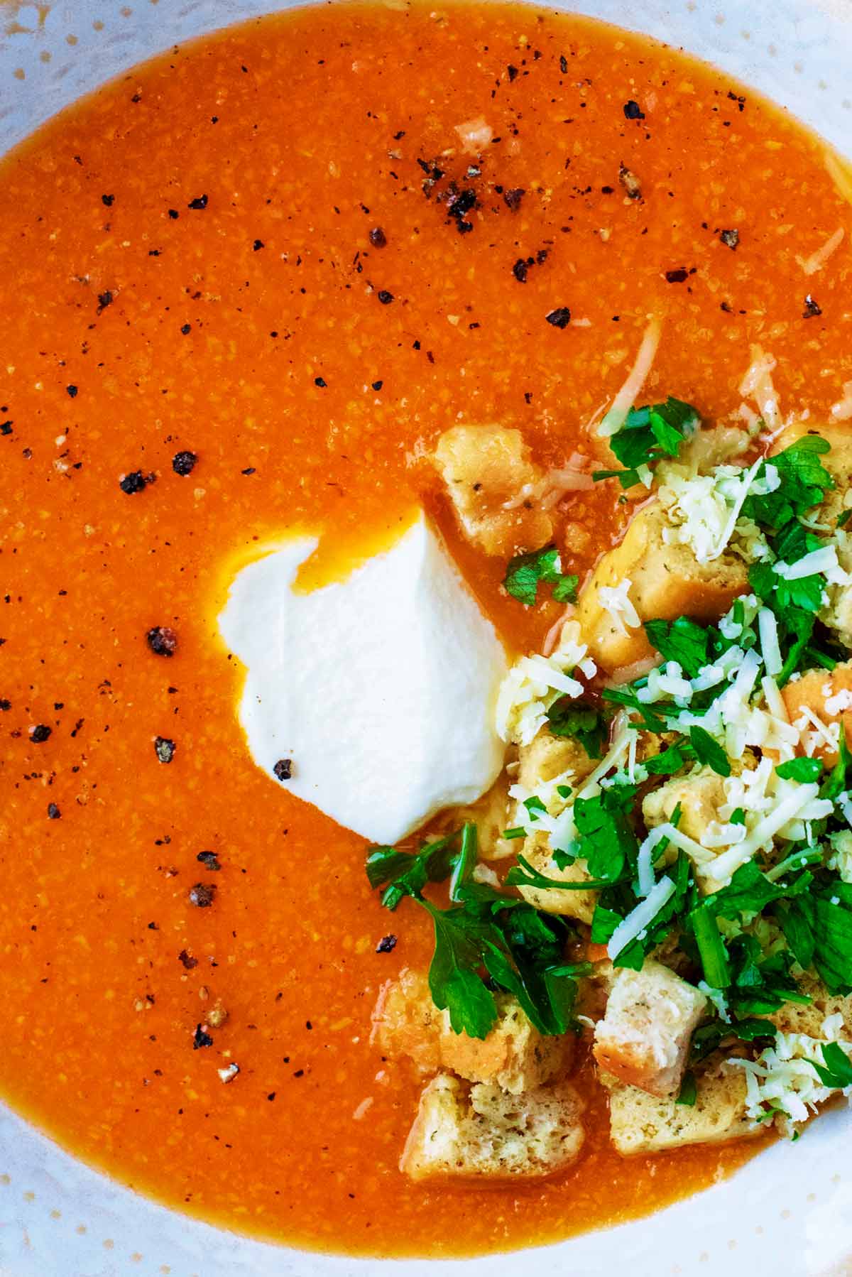 Sweet Potato Soup with cream, croutons, chopped herbs and black pepper.