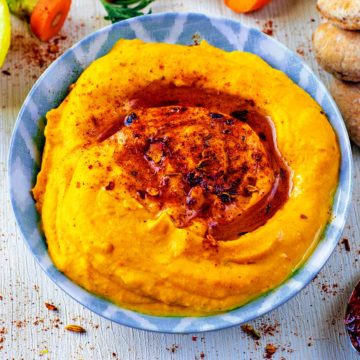 Roasted Carrot Hummus in a blue dish.