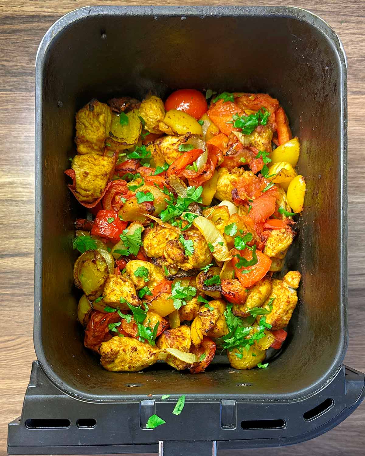 Chopped coriander leaves scattered over the cooked chicken and veg.