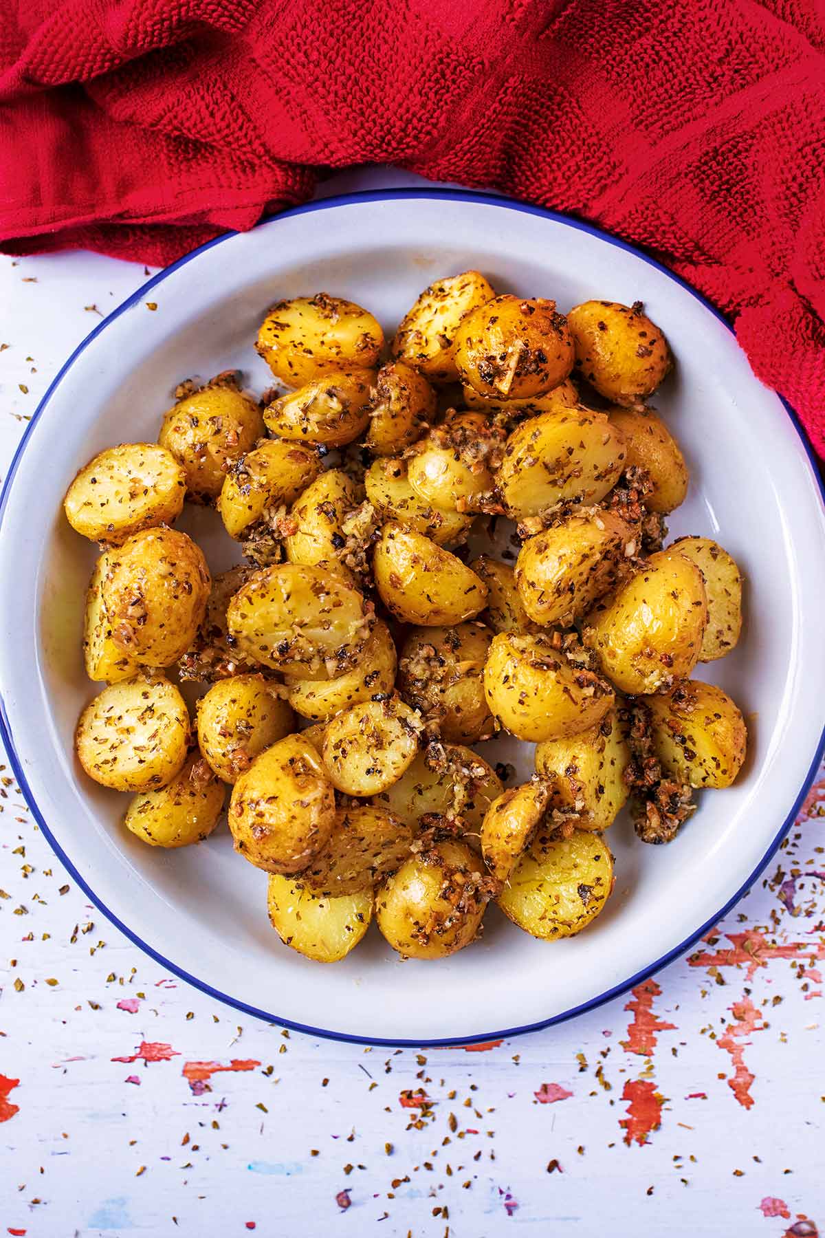 Italian Roasted Potatoes in a white, blue rimmed dish.