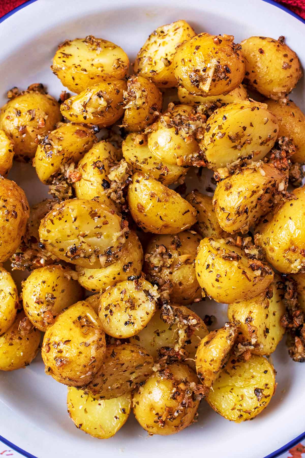 Roasted Potatoes in a bowl on a wooden surface.