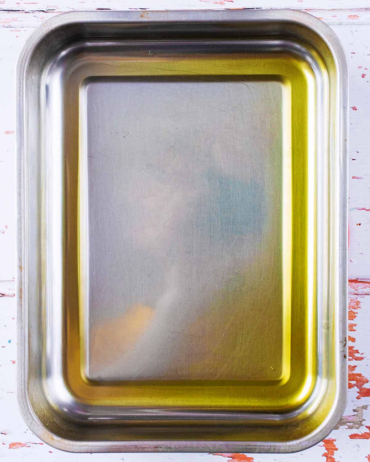 A large roasting tin containing hot oil.