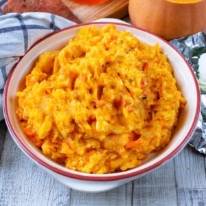 A bowl of Vegetable Mash on a wooden surface.