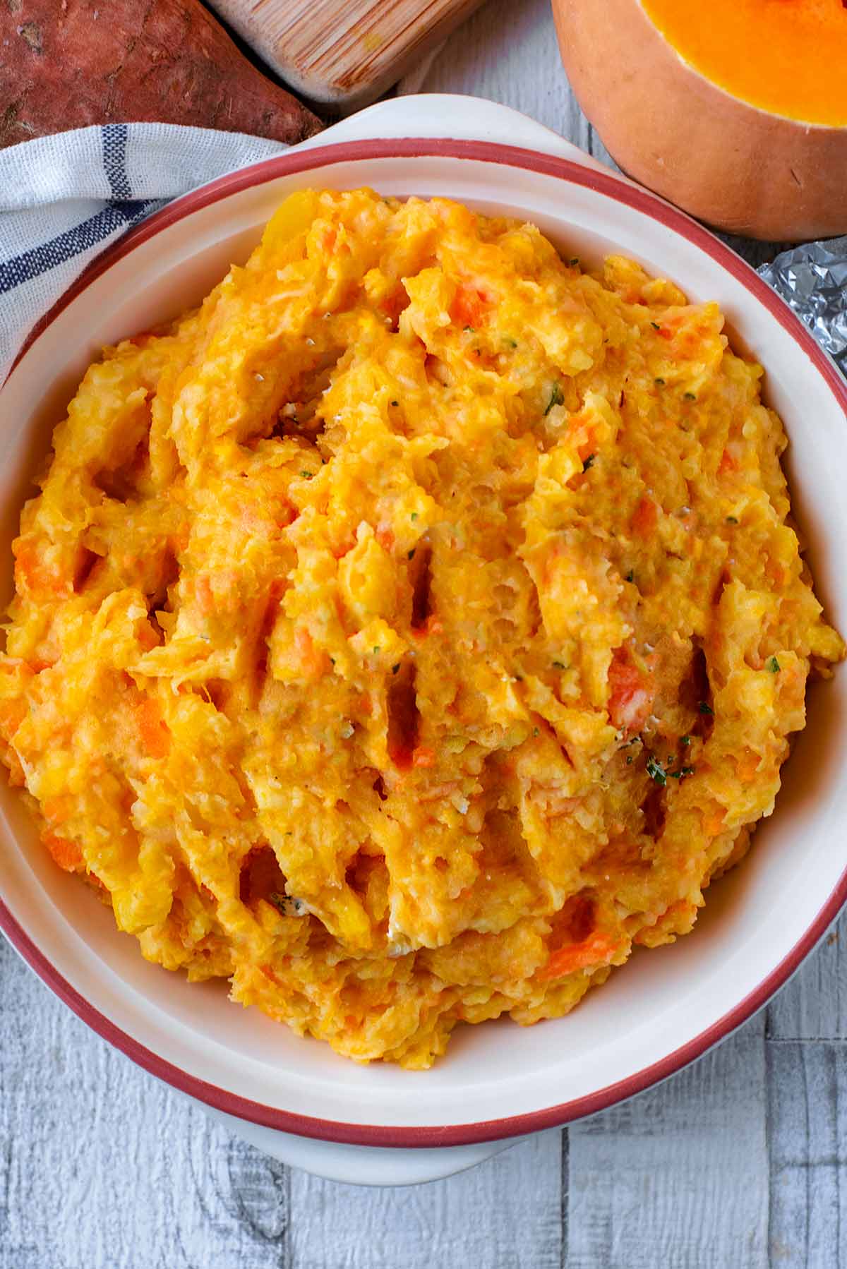 Orange coloured Vegetable Mash in a cream dish.