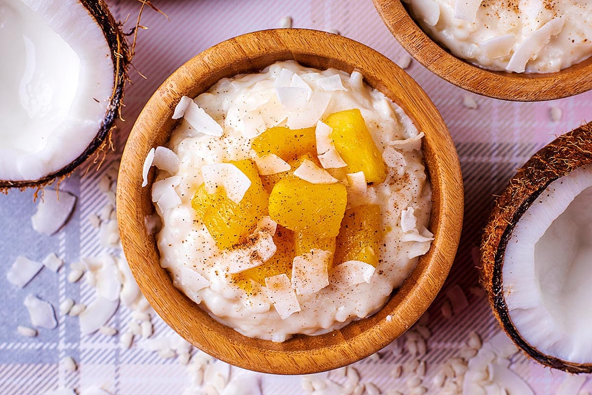 Coconut rice pudding in a bowl with pineapple on top