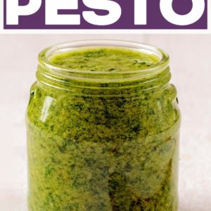 A jar of mixed herb pesto with a text title overlay.