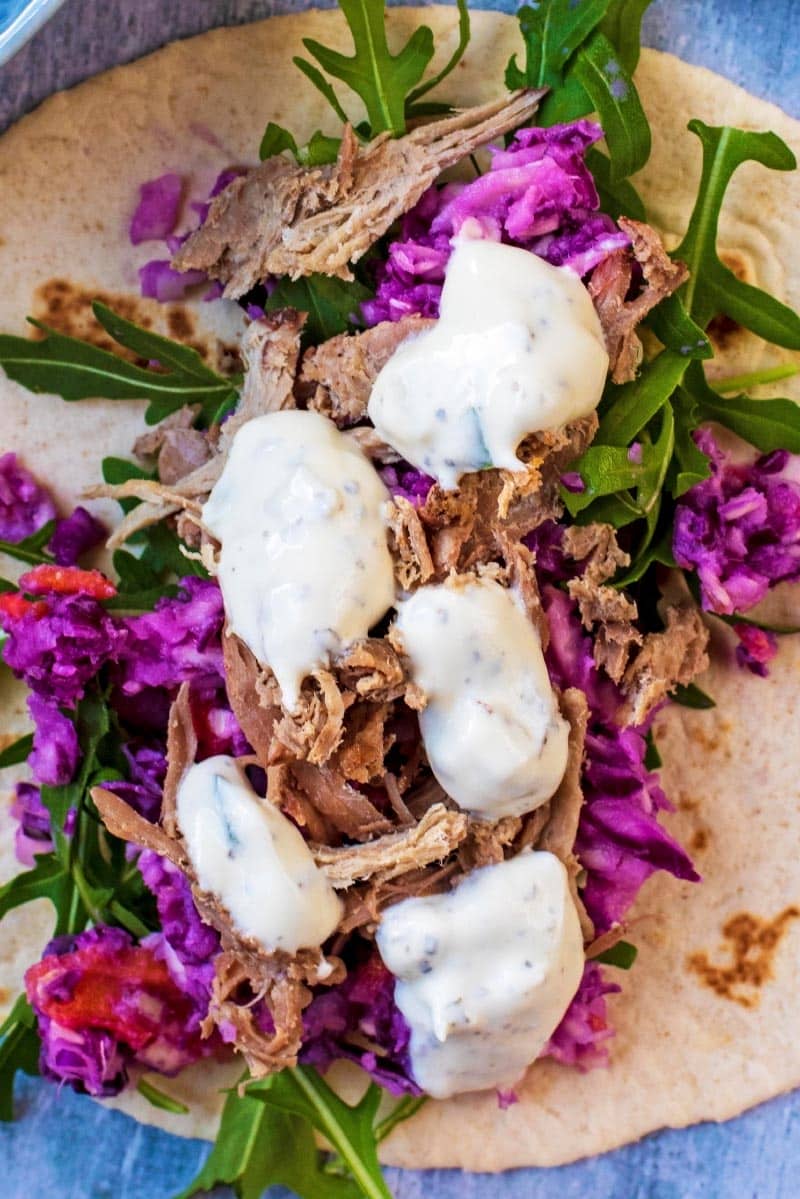 Pulled lamb with slaw and dollops of tzatziki.