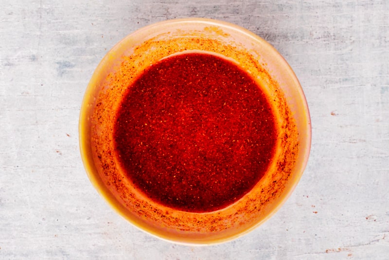 A bowl of red marinade.