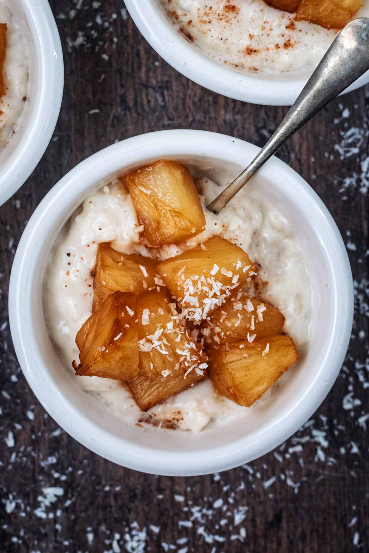 Rice pudding topped with pineapple and desiccated coconut.