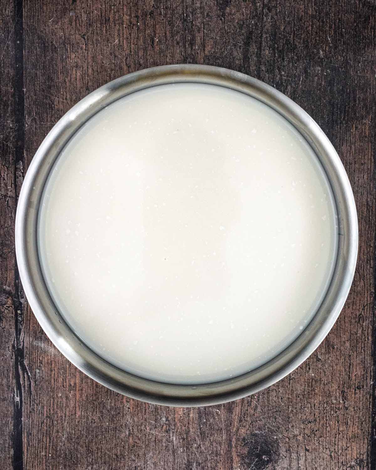 Milk and pudding rice in a saucepan.