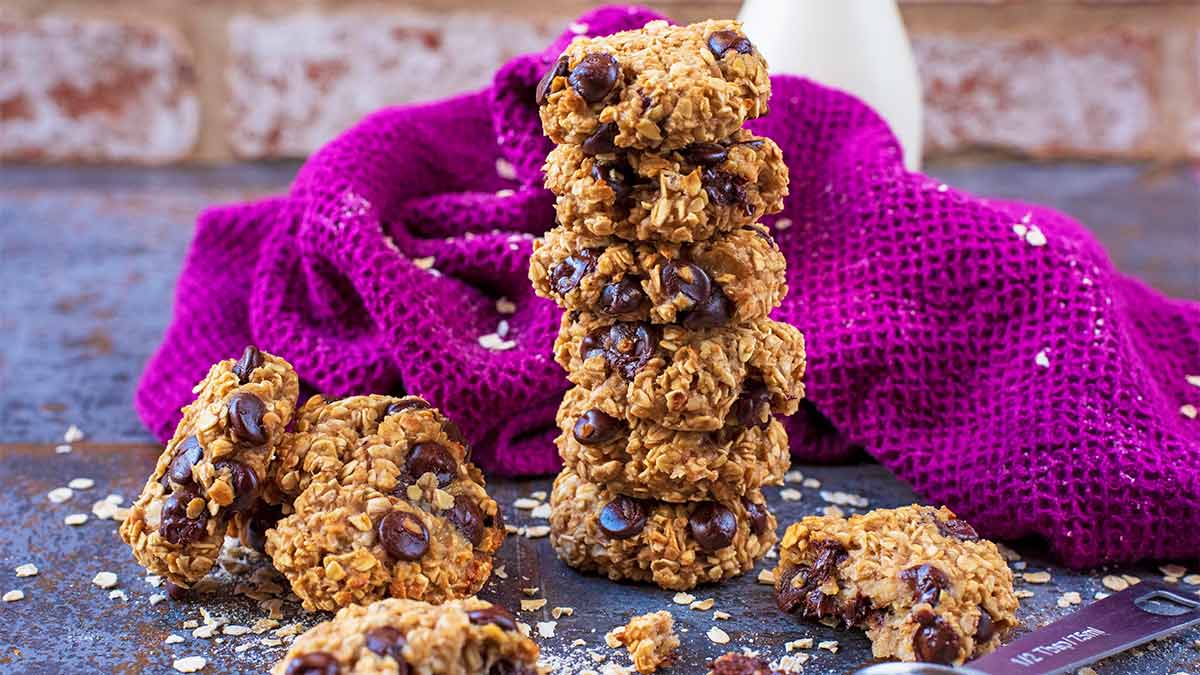 A stack of banana oat cookies in front of a purple towel.