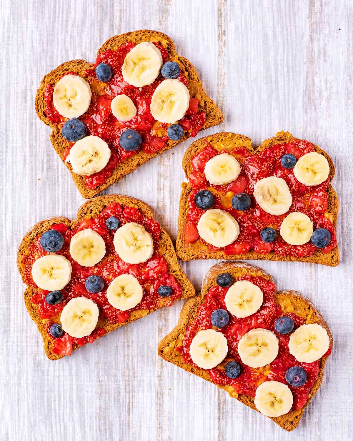 Banana slices and blueberries added on top of the strawberry jelly.