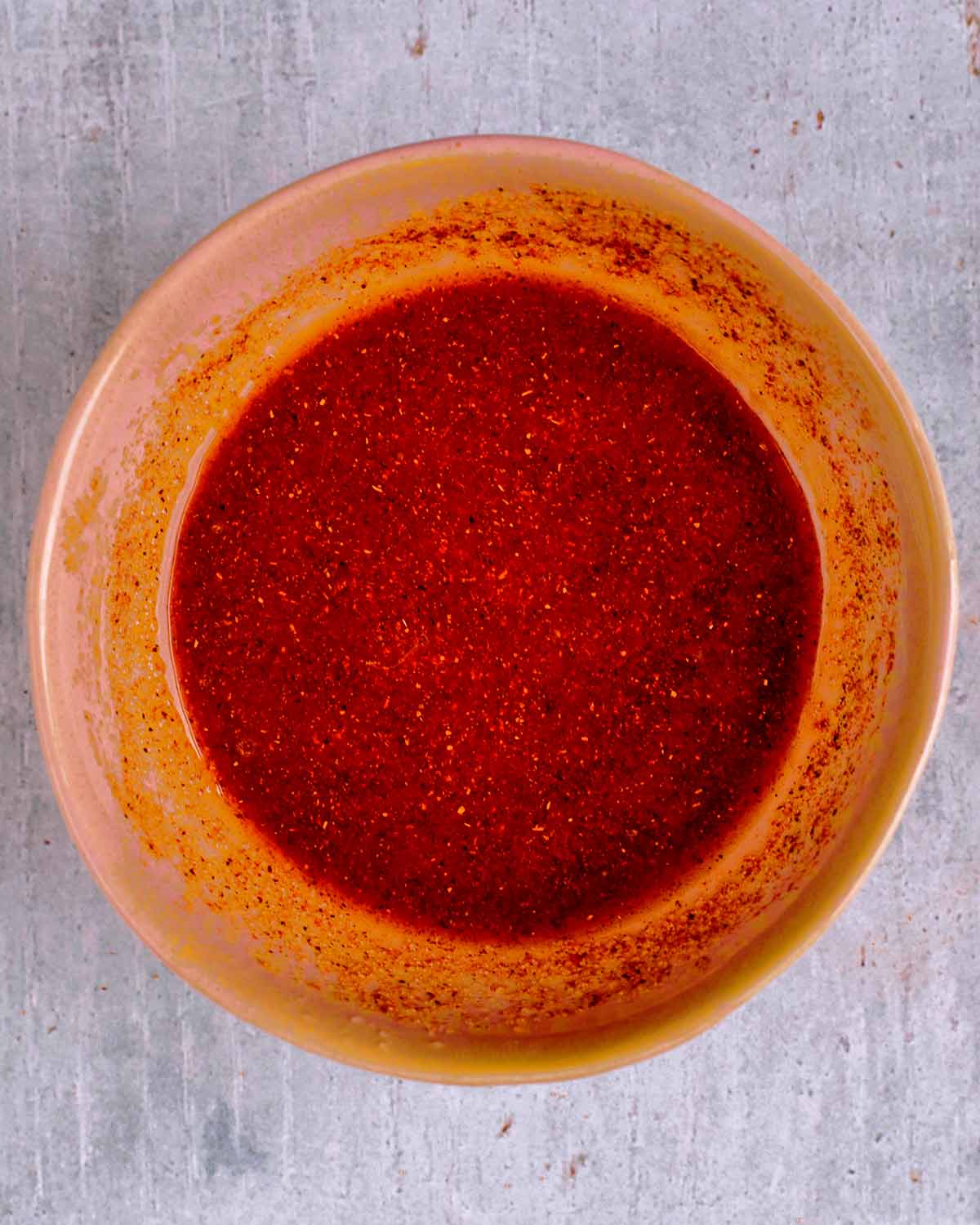 A bowl of red marinade.