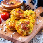 Breakfast Egg Muffins on a serving board in front of a pot of coffee