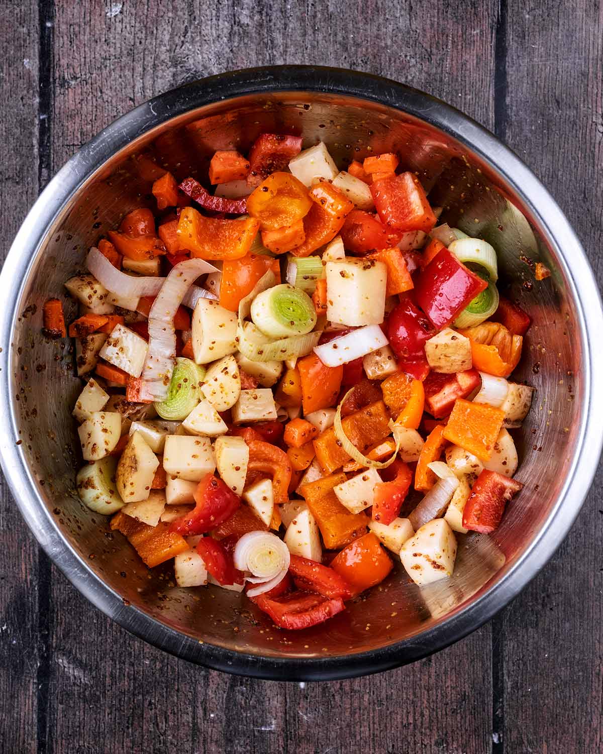 Chopped vegetables added to the bowl.