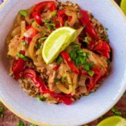 Slow Cooker Thai Chicken Curry in a white bowl, topped with a lime wedge