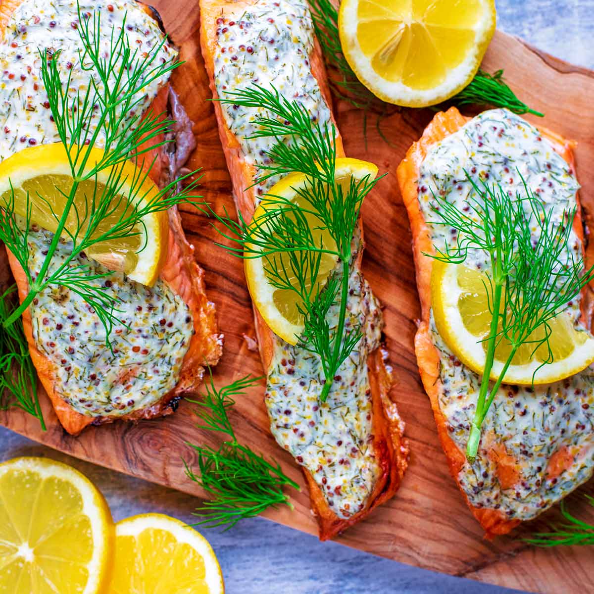 Creamy Dill Salmon topped with lemon slices and sprigs of dill.