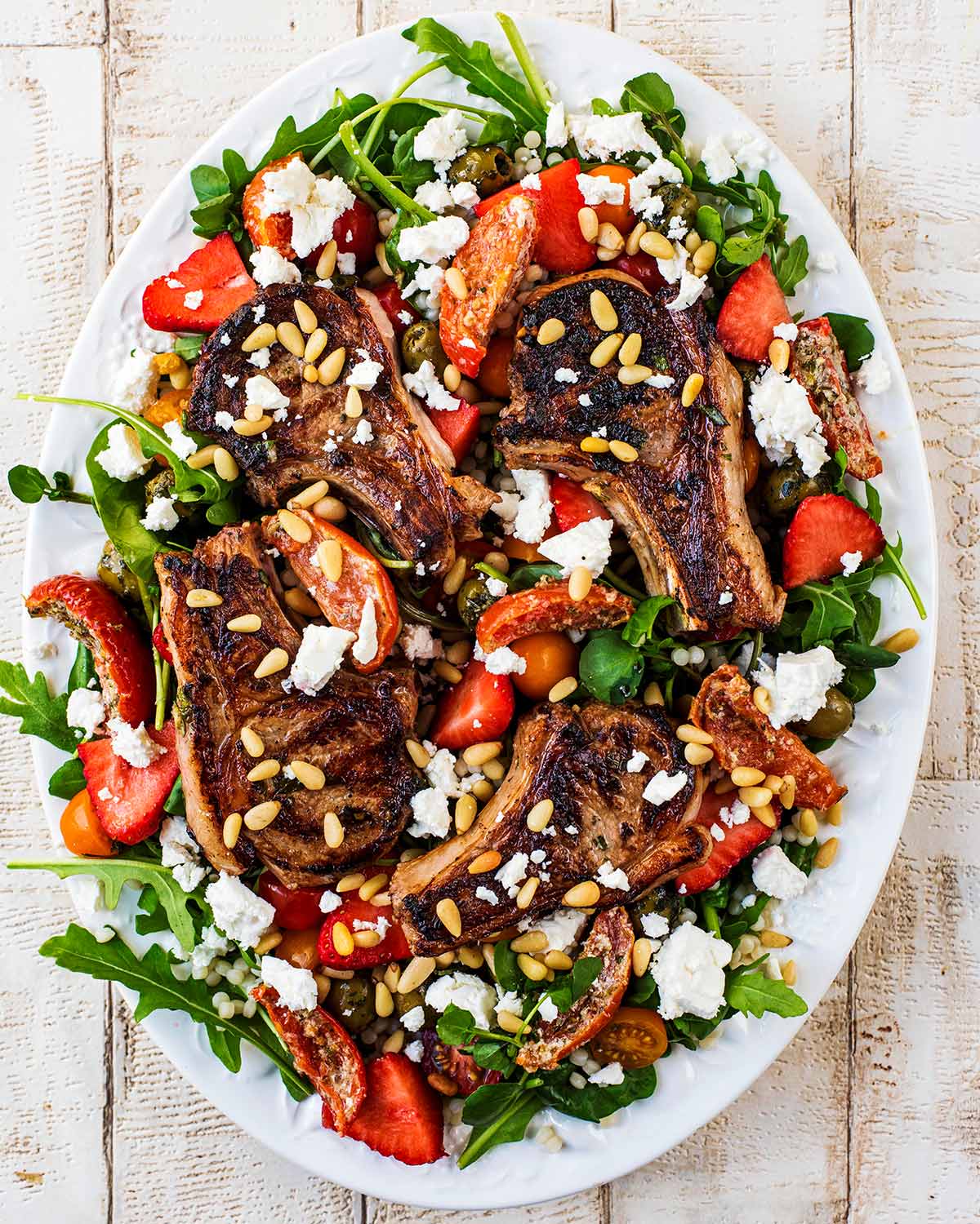 Sun-dried tomatoes, crumbled feta and pine nuts added on top of the lamb chops.