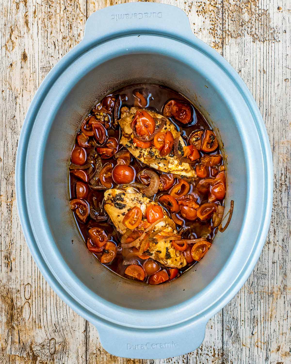 Cooked balsamic chicken in the slow cooker pot.