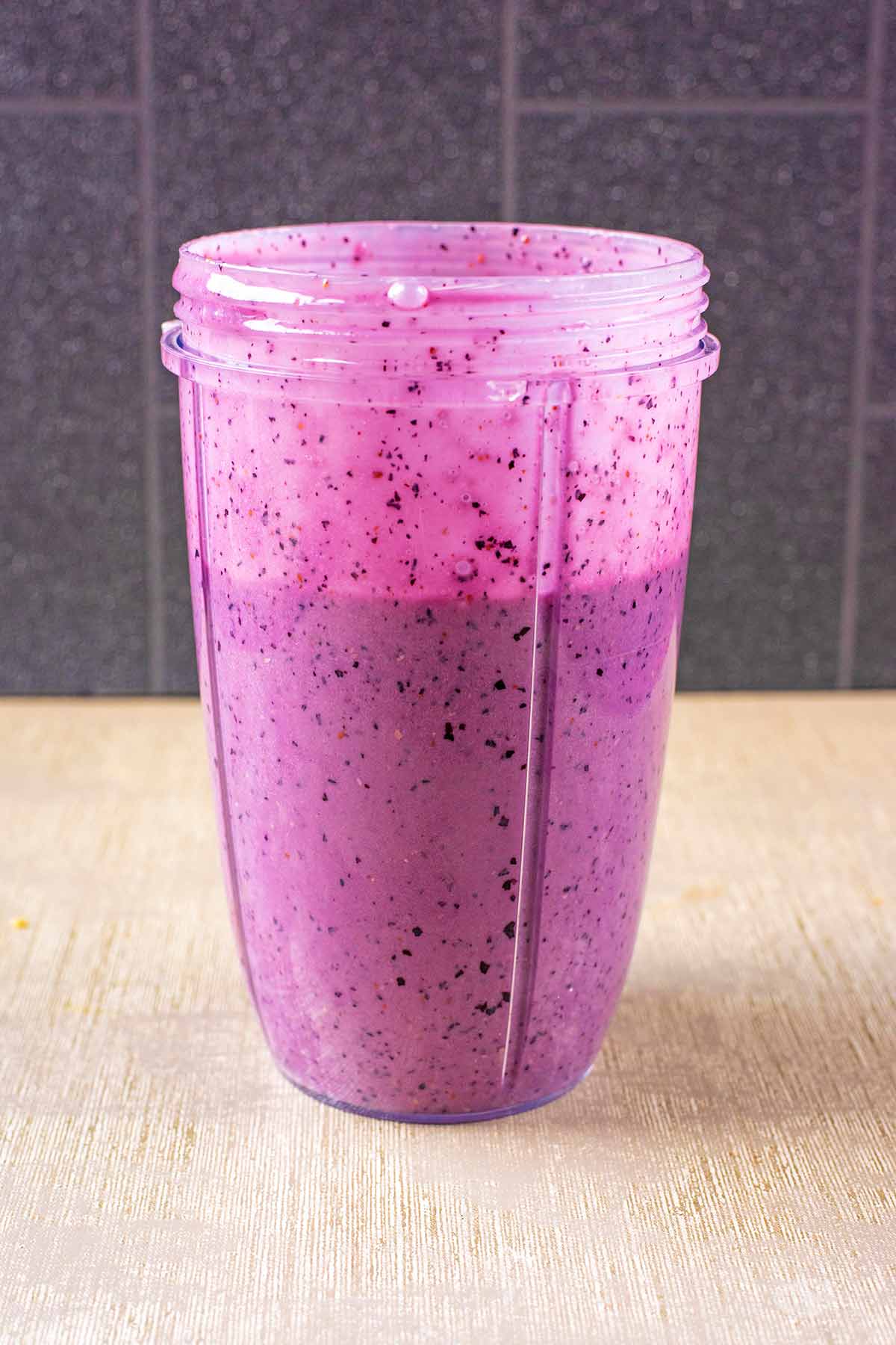 A purple coloured smoothie in a blender jug.