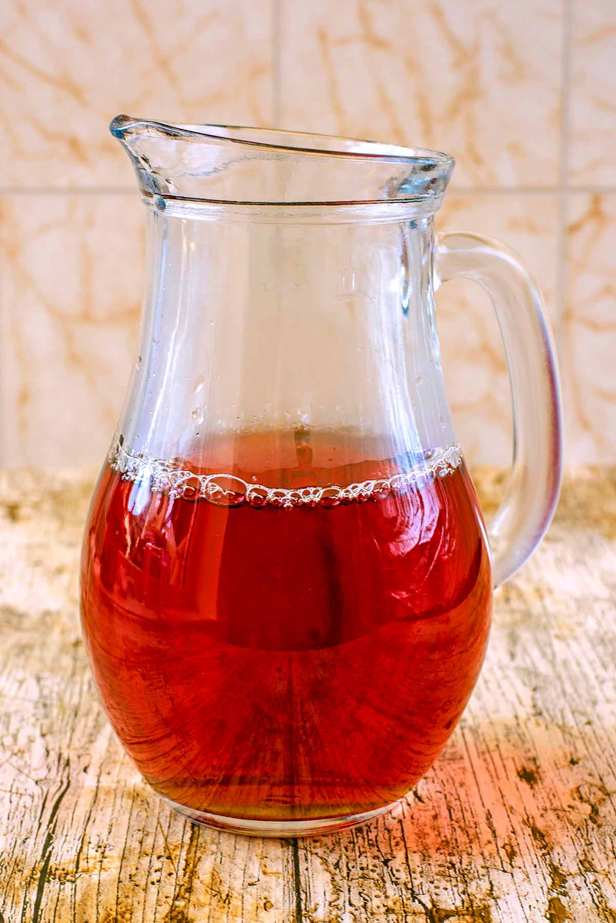 A glass jug half full of tea.