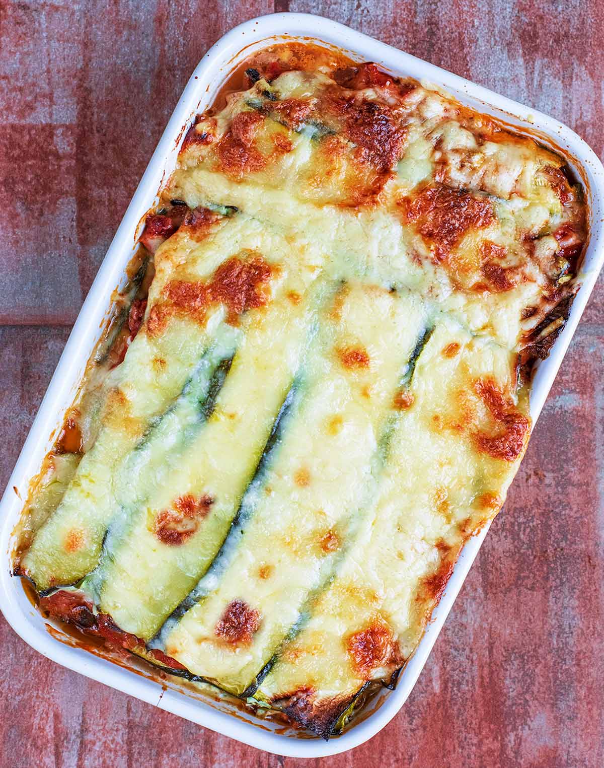 Low carb lasagna showing a courgette and melted cheese topping.