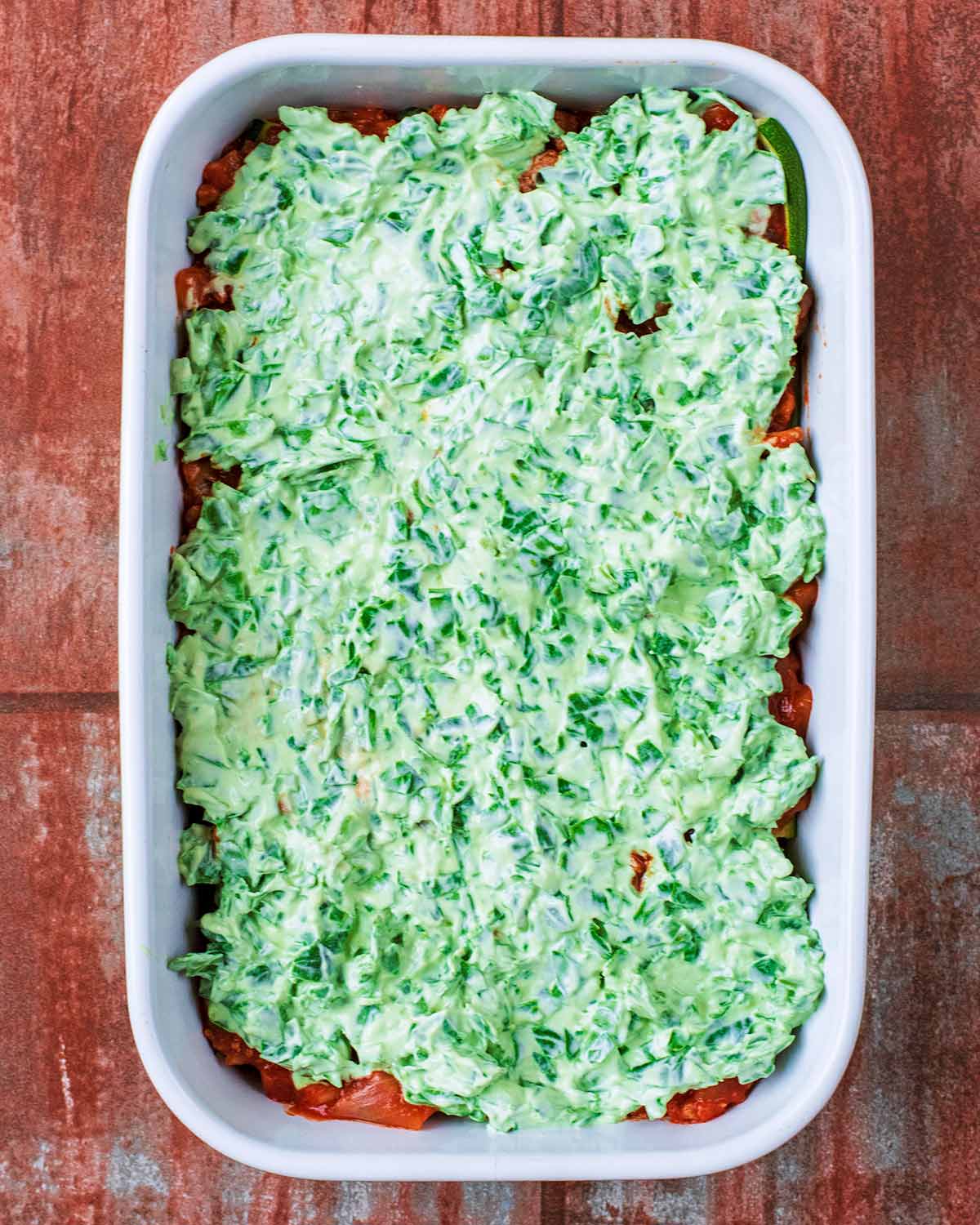 The creamy spinach mixture added to the top of the courgette layer.