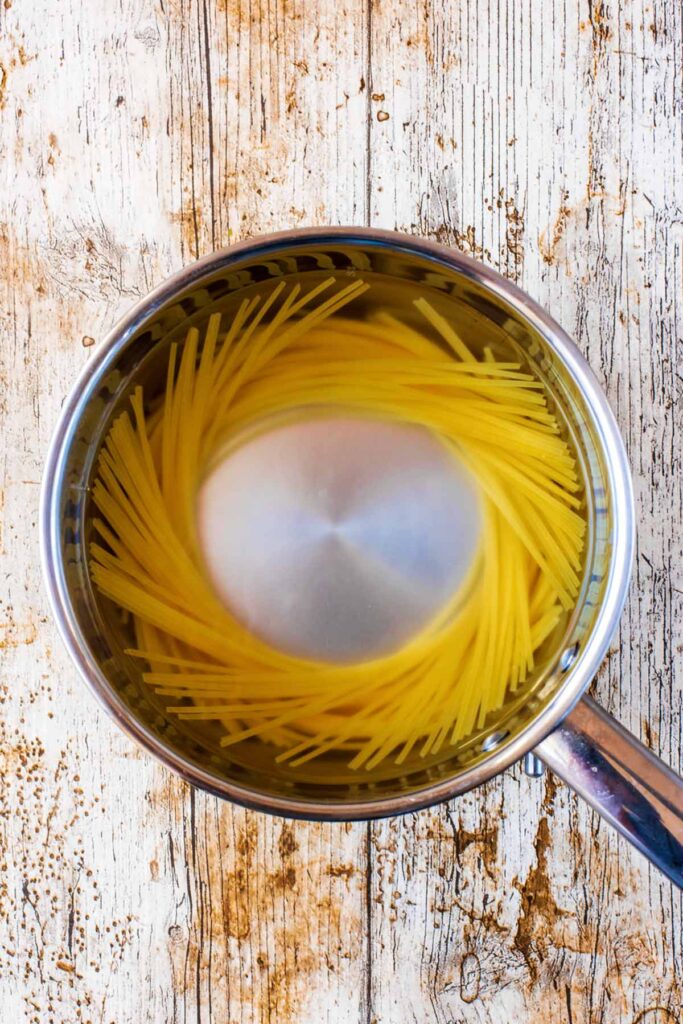 A saucepan containing spaghetti.