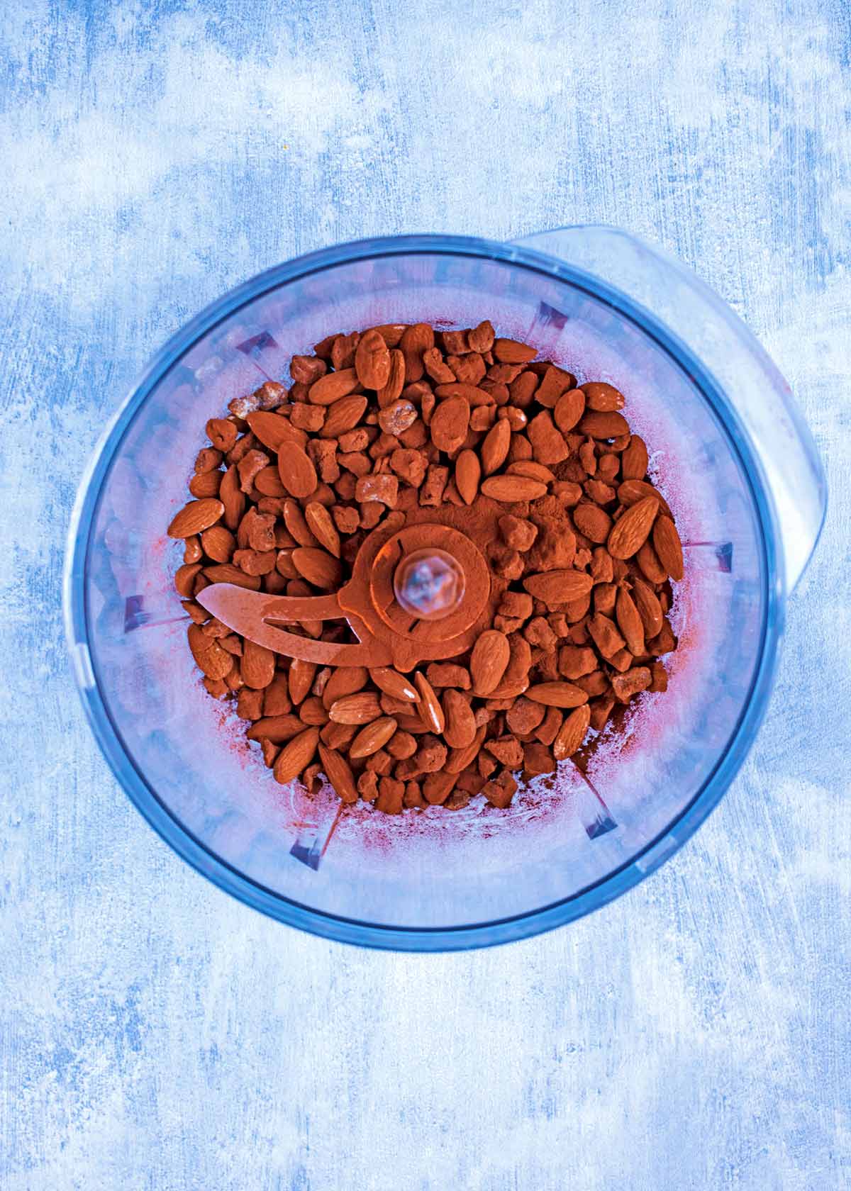 Almonds and cocoa powder in a food processor.